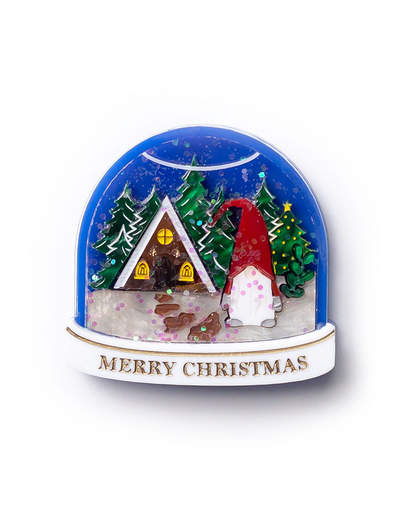 Christmas-themed snow globe with a house, trees, and a gnome on a white background